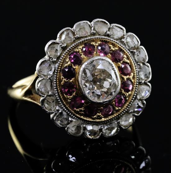An 18ct gold, ruby and diamond target cluster ring, size N.